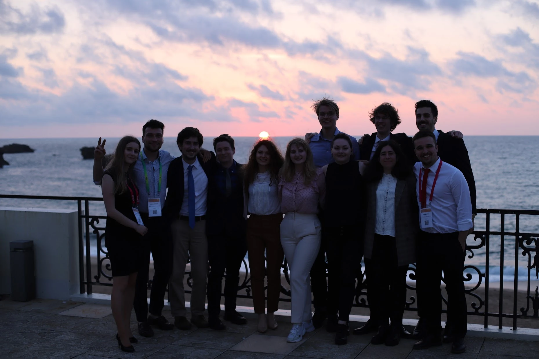 A group photo at sunset on a terrace above the sea in Biarritz