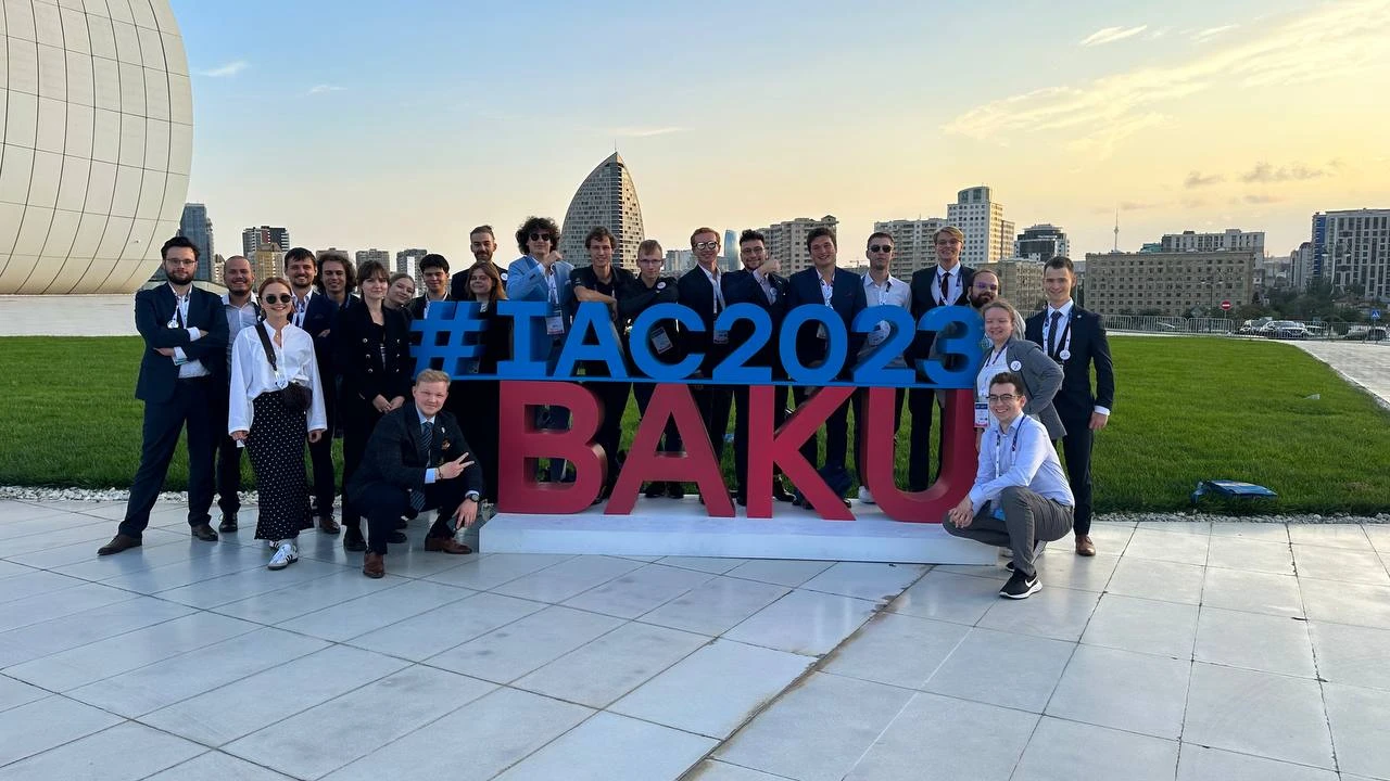 A group photo at the #IAC2023 BAKU sign